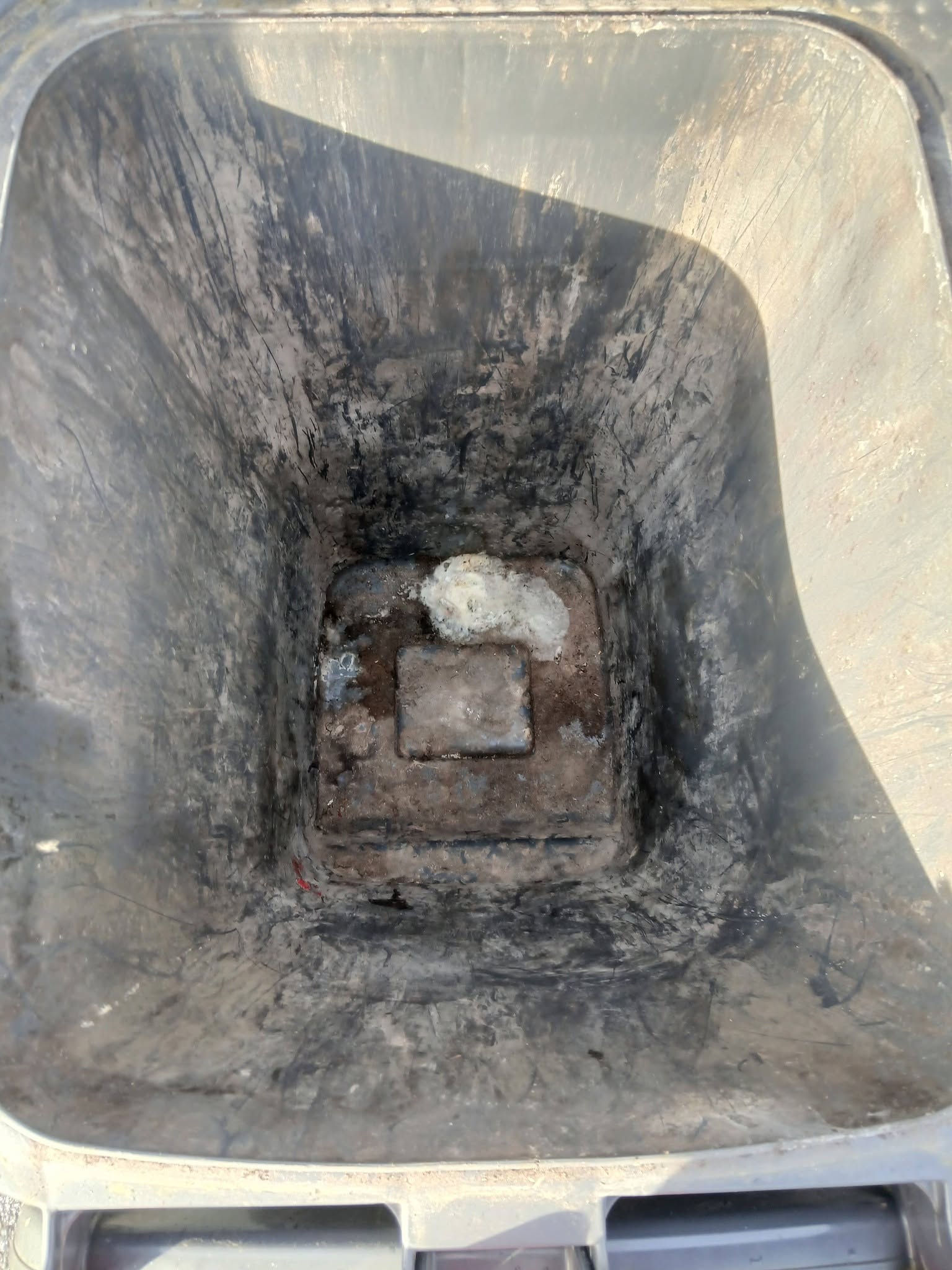 Dirty wheelie bin interior before cleaning